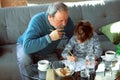 Grandfather and his grandson spending time insulated at home, stadying, writing, drawing or playing together