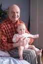 Grandfather holding a caucasian newborn baby girl Royalty Free Stock Photo