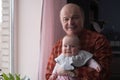 Grandfather holding a caucasian newborn baby girl Royalty Free Stock Photo