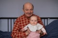 Grandfather holding a caucasian newborn baby girl Royalty Free Stock Photo