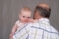 Grandfather holding a caucasian 8 month baby girl Royalty Free Stock Photo