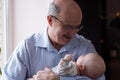 Grandfather holding a caucasian newborn baby girl Royalty Free Stock Photo