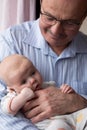 Grandfather holding a caucasian newborn baby girl Royalty Free Stock Photo