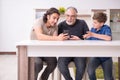 Grandfather learning new technology from son and grandson