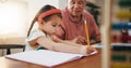 Grandfather, little girl and writing in book for learning, literature or education together on desk at home. Grandpa Royalty Free Stock Photo