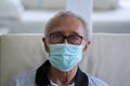 Grandfather looking at camera with facial mask