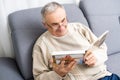 Grandfather looking at photo at home