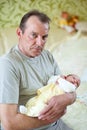 Grandfather lovingly holding his newborn grandson Royalty Free Stock Photo