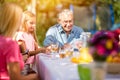 Grandfather playing cards outdoors Royalty Free Stock Photo