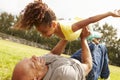 Grandfather Playing Game With Granddaughter In Park Royalty Free Stock Photo