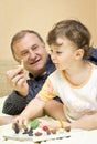 Grandfather playing with granddaughter Royalty Free Stock Photo