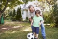 Grandfather Playing Soccer In Garden With Grandson Royalty Free Stock Photo