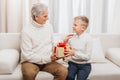 Grandfather presenting christmas gift to grandson