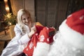 Grandfather puts gifts together with the snow maiden and cannot share what to give to anyone