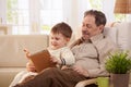 Grandfather reading tales to grandson