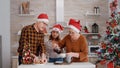 Grandfather serving child with baked delicious cookie while grandmother putting coffee Royalty Free Stock Photo