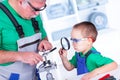 Grandfather showing to grandchild the thread cutting die