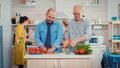 Grandfather and son preparing a salad Royalty Free Stock Photo