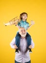 Grandfather and son piggyback ride with plane and wooden toy truck. Men generation granddad and grandchild. Elderly old