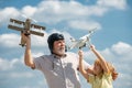 Grandfather and son with plane and quad copter drone over blue sky. Men generation granddad and grandchild. Elderly old