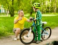 Grandfather talking with his grandson riding a bicycle Royalty Free Stock Photo