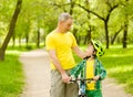 Grandfather talking with his grandson riding a bicycle Royalty Free Stock Photo