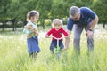 Grandfather teaches grandchildren to ride a bike. Royalty Free Stock Photo