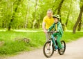 Grandfather teaches his grandson to ride a bike Royalty Free Stock Photo