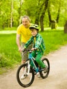 Grandfather teaches his grandson to ride a bike Royalty Free Stock Photo