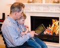 Grandfather teaches his grandson to use a tablet computer Royalty Free Stock Photo