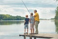 Grandfather Teaching Grandsons To Fish Royalty Free Stock Photo