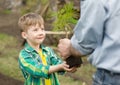 Grandfather transmits to his grandson cedar sapling Royalty Free Stock Photo