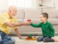 Boy playing with grandfather in building kit Royalty Free Stock Photo