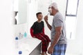 Grandfather Wearing Pajamas In Bathroom Shaving Whilst Grandson Watches