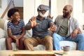 Grandfather Wearing VR Headset As Multi-Generation Male Family Sit On Sofa At Home Together Royalty Free Stock Photo