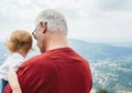 Grandfather with white hair holding little child