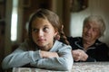 Grandma braids her granddaughter`s hair. Family.