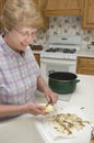 Grandma Cooking in her Kitchen, Peeling Potatoes Royalty Free Stock Photo