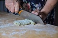 Grandma cutting fresh pasta with knife