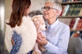 A grandma is full of emotions while spending time at home with her little grand daughter with angel wings. Family, home, love, Royalty Free Stock Photo