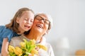 Grandma and girl smiling and hugging