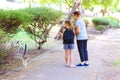 Grandma and granddaughter looking at homeless kitty in outdoor park. Royalty Free Stock Photo