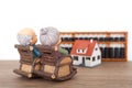 Grandma and grandpa sitting in rocking chair looking at house model and abacus tool in the distance Royalty Free Stock Photo