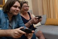 Grandma and grandson having fun playing video games at home. Royalty Free Stock Photo