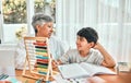 Grandma help, child abacus learning and home studying in a family house with education and knowledge. Senior woman, boy