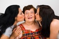 Grandma kissed by two granddaughters