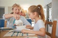 Grandma knows how I like my cereal. a little girl having breakfast with her grandmother. Royalty Free Stock Photo