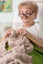 Grandma lying in bed and knitting Royalty Free Stock Photo