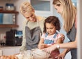 Grandma, mother and child baking in kitchen together while girl learns to mix cake mixture, pancake batter or muffin mix Royalty Free Stock Photo