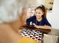 Grandma Playing Checkers Board Game With Granddaughter At Home Royalty Free Stock Photo